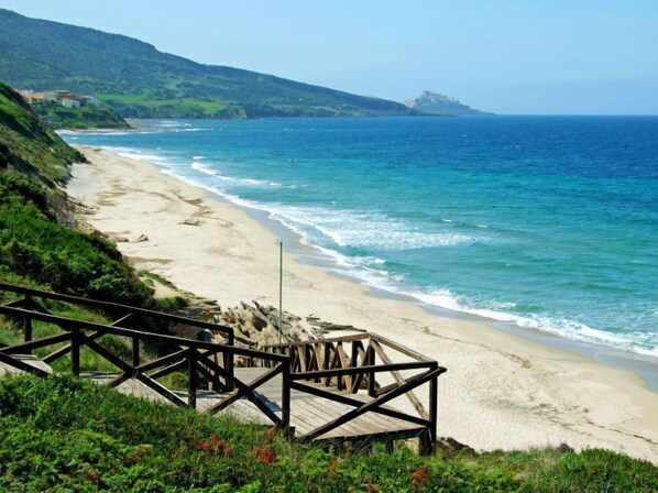 Walk along the boardwalk to the sandy beach.