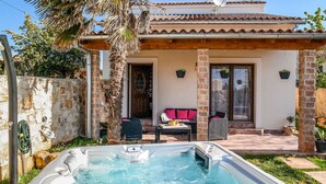 A residential property with a swimming pool, a patio with outdoor furniture, and a stone wall. - Villa Aurora by Interhome (Pula)