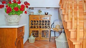 A small room with a wooden cabinet, a potted plant, a wicker basket, and a wooden staircase. - Vacation home Lea by Interhome (Opatija/Rukavac)