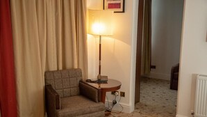 A room with a chair, a lamp, and a radiator. - The Ladbrooke Hotel (Birmingham)