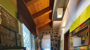 A narrow hallway with a bunk bed, a sink, and a shower.