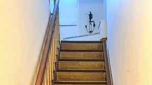 A wooden staircase with a handrail and a star-shaped design on the left side. - Haus Irmgard by Interhome (Blankenrath)