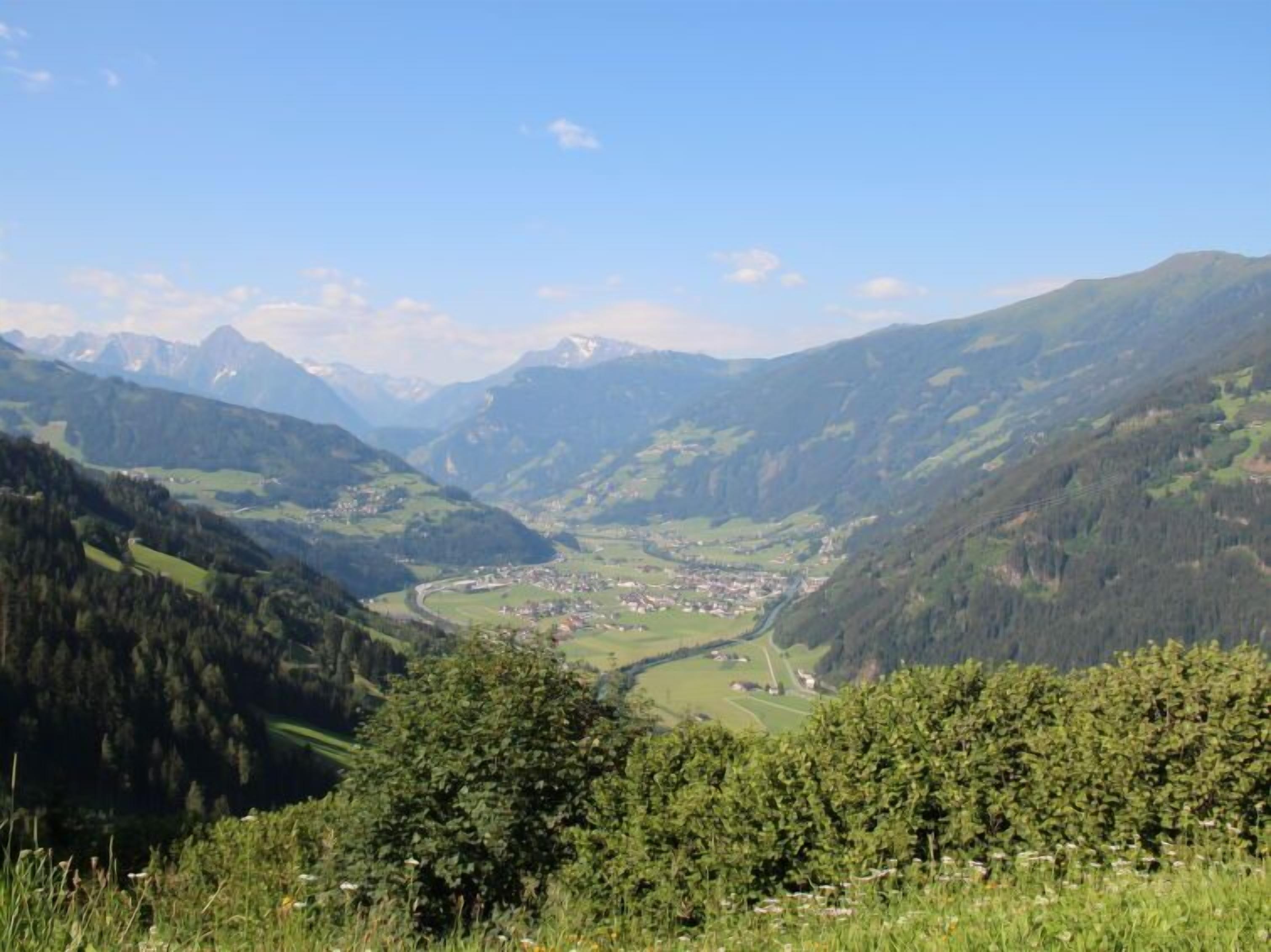 A valley with a town nestled among mountains.