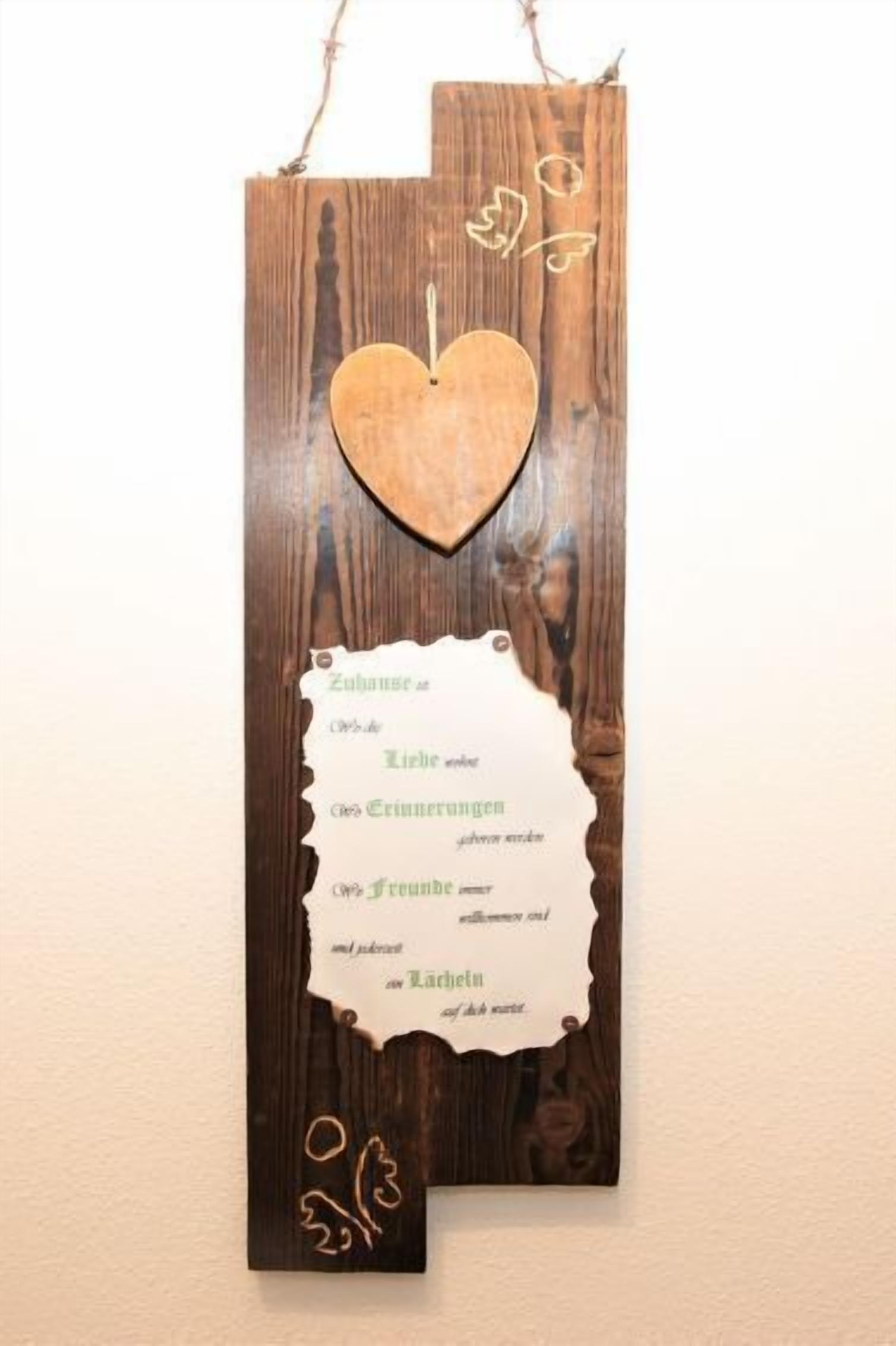 A wooden sign with a heart-shaped cutout and a handwritten message.