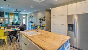 A modern kitchen with white cabinets, stainless steel appliances, and a wooden countertop. - 7 Mi to Dtwn Denver: Arvada Home w/ Patio (Arvada)