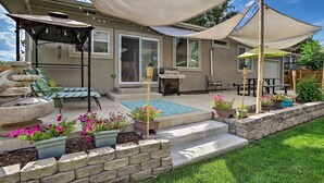 A covered patio area with outdoor furniture, a barbecue grill, and potted plants. - 7 Mi to Dtwn Denver: Arvada Home w/ Patio (Arvada)