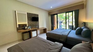 Habitación de hotel con cama, escritorio, televisor de pantalla plana, refrigerador pequeño y ventana con vistas a zonas verdes.