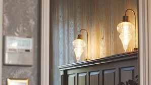A hotel room with a bed, bedside table, and wall-mounted light fixtures. - Medar Hotel (Istanbul)