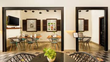 A hotel reception area with a check-in counter, seating arrangements, and informational posters on the wall.