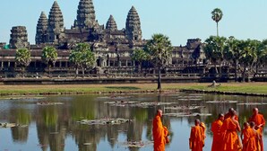 A temple complex with multiple towers and a reflection in the water. - Baahu Villa (Siem Reap)