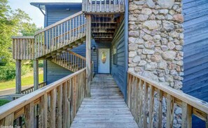 Staircase leads to a covered entryway with a door and a window.