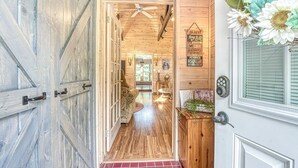 A wooden interior with a hallway leading to a room.