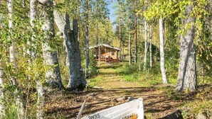 A cabin surrounded by birch trees in a forest. - Niemenkärki, vaikon loma 8 by Interhome (Kaavi)