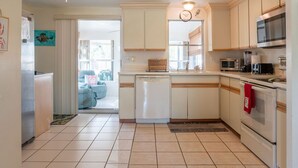 A kitchen with white cabinets, a dishwasher, a microwave, and an oven. - Great location! Private fenced backyard. March/April 2027 available (Englewood)