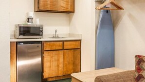 A compact kitchenette with a microwave, coffee maker, and dishwasher. - Ashland Valley Inn (Ashland)