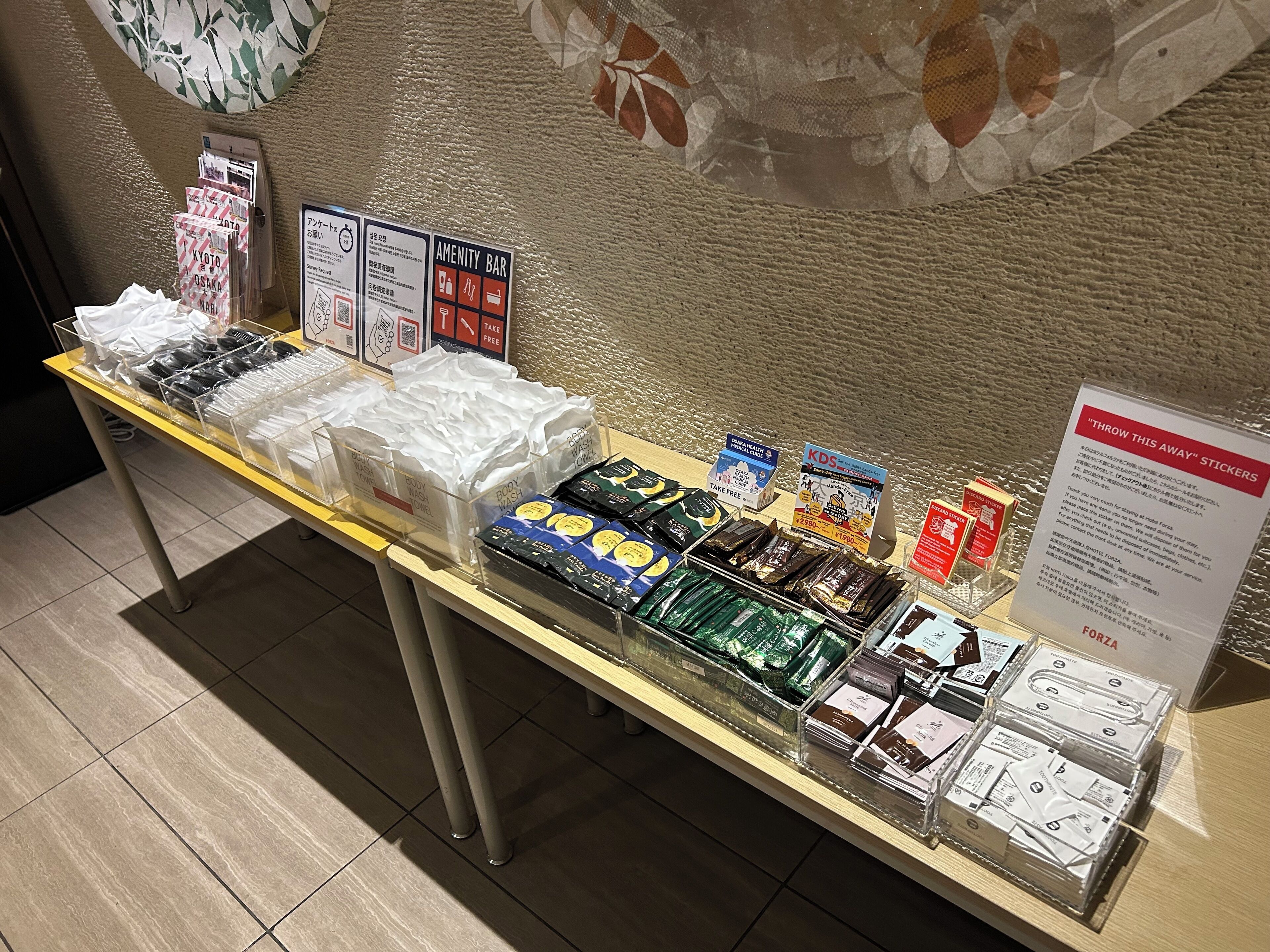 A display table with various toiletries and amenities, including body wash, shampoo, and hair care products.