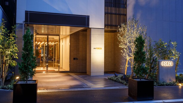 A modern hotel entrance with a glass door, a sign reading "FORZA", and a well-lit pathway leading to the entrance. - Hotel Forza Osaka Kitahama (Osaka)