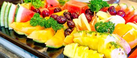 A fruit platter with various fruits and garnishes.