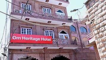 A building with a sign reading "Om Heritage Hotel."