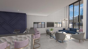 A modern living room with a sofa, armchairs, a coffee table, and a TV.
