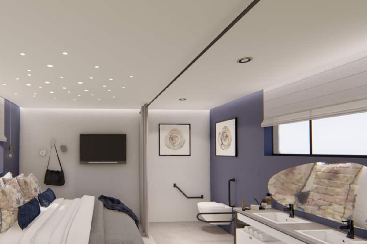 A modern bedroom with a bed, bedside tables, a TV, and a bathroom with a sink and mirror.