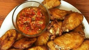 A plate of fried plantains and chicken wings with a side of salsa. - Rendezvous Hotel (Abuja)