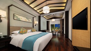 A modern hotel room with a large bed, a desk, a chair, a TV, and a view of the outdoors. - SSAW Boutique Hotel Liuzhou Garden (Liuzhou)