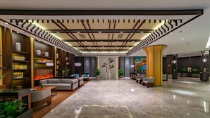 A spacious lobby with a marble floor, modern furniture, and a central staircase. - SSAW Boutique Hotel Liuzhou Garden (Liuzhou)