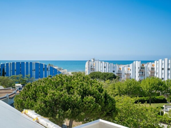 A coastal residential area with modern buildings, a clear sky, and a view of the sea. - Cap Sud by Interhome (La Grande Motte)