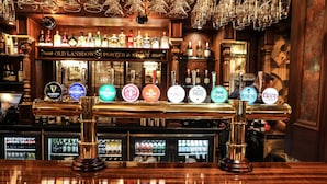 A bar with multiple taps and a variety of bottles in the background. - The Lansdowne Hotel (Belfast)