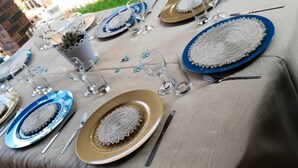 A table set with plates, glasses, and cutlery, arranged for a meal. - Lapeng Home Away from Home (Maseru)