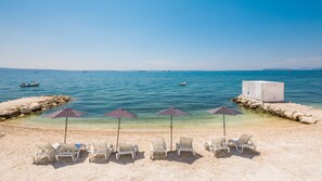 On the beach, sun loungers, beach umbrellas, beach bar