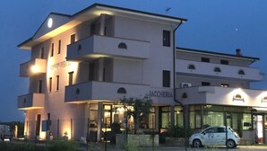 A modern building with a restaurant named "JACCHERIA" on the ground floor.