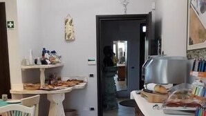 A kitchen with a dining area, a refrigerator, a sink, and a window.