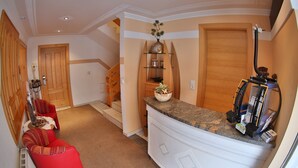 A modern kitchen with a granite countertop, wooden cabinets, and a built-in oven. - Apart Altamira (Ischgl)