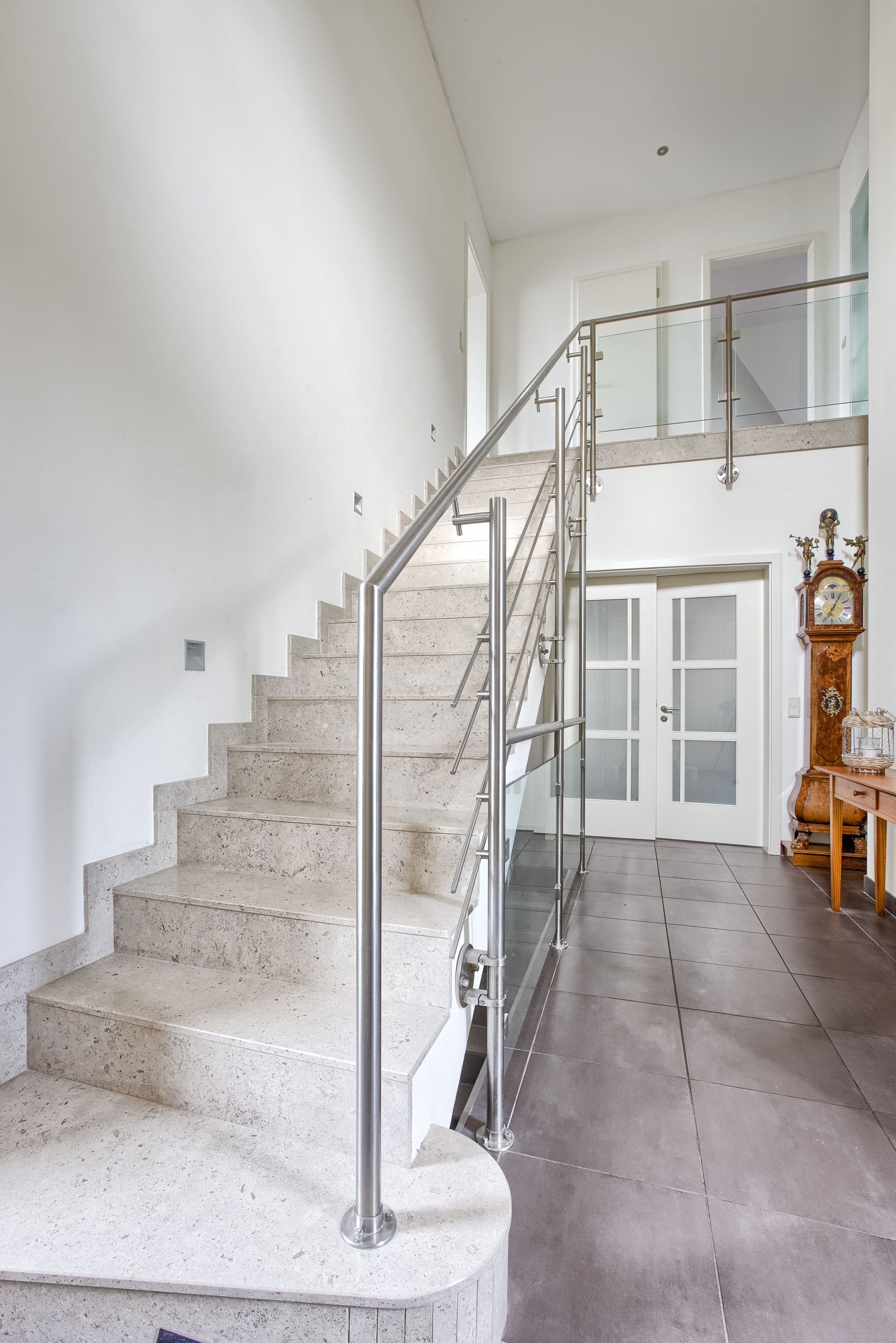 A staircase with metal railings leading to a second floor.