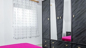 A bedroom with a bed, a wardrobe, and a mirror. - Apartment Vilma by Interhome (Balatonmariafurdo)