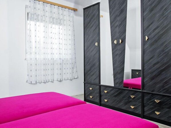A bedroom with a bed, a wardrobe, and a mirror. - Apartment Vilma by Interhome (Balatonmariafurdo)