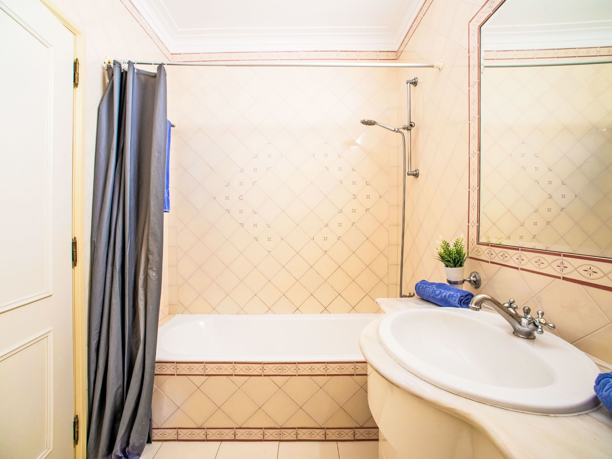 A bathroom with a bathtub, a sink, and a shower.