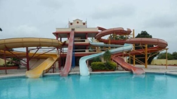 A water park with multiple slides and a pool.