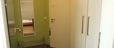 A room with a bed, a door, and a radiator.