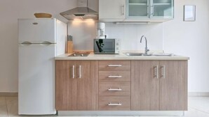 A modern kitchen with a white refrigerator, a coffee maker, and a microwave on the counter. - Villa Alpa by Interhome (Umag)