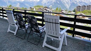 A balcony with two Adirondack chairs overlooking a mountain view. - Christiania I I4 by Interhome (Nendaz)