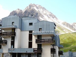 A modern building with balconies and a mountain backdrop. - Plein Soleil (Val Claret) by Interhome (Tignes)