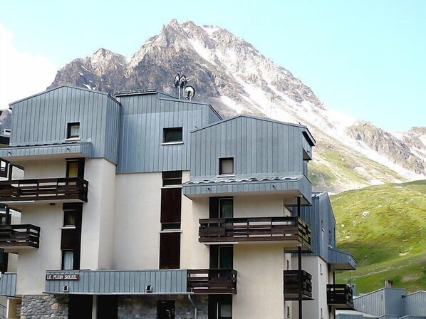 A modern building with balconies and a mountain backdrop. - Plein Soleil (Val Claret) by Interhome (Tignes)