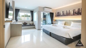 A modern hotel room with a large bed, a desk, a flat-screen TV, and a city view. - Proud Khaoyai (Pak Chong)