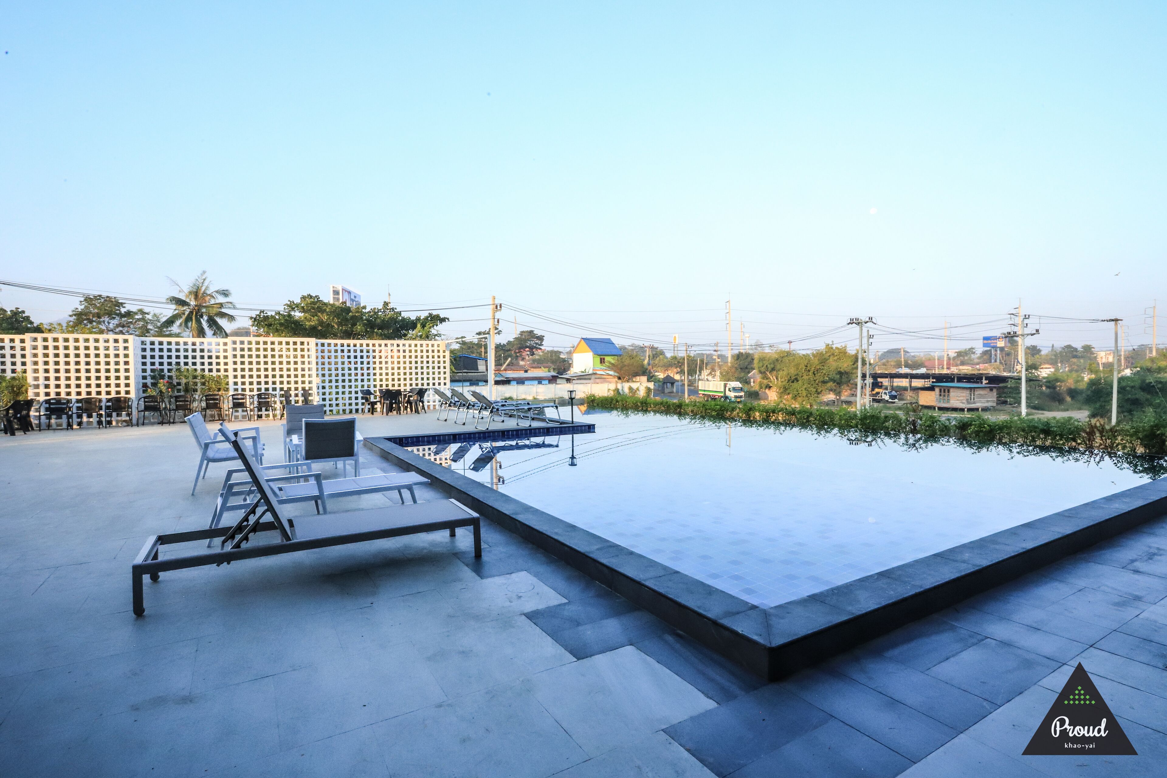An outdoor swimming pool with lounge chairs and a seating area.