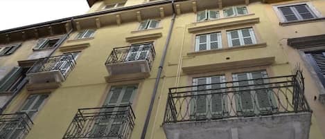A multi-story building with balconies and windows.