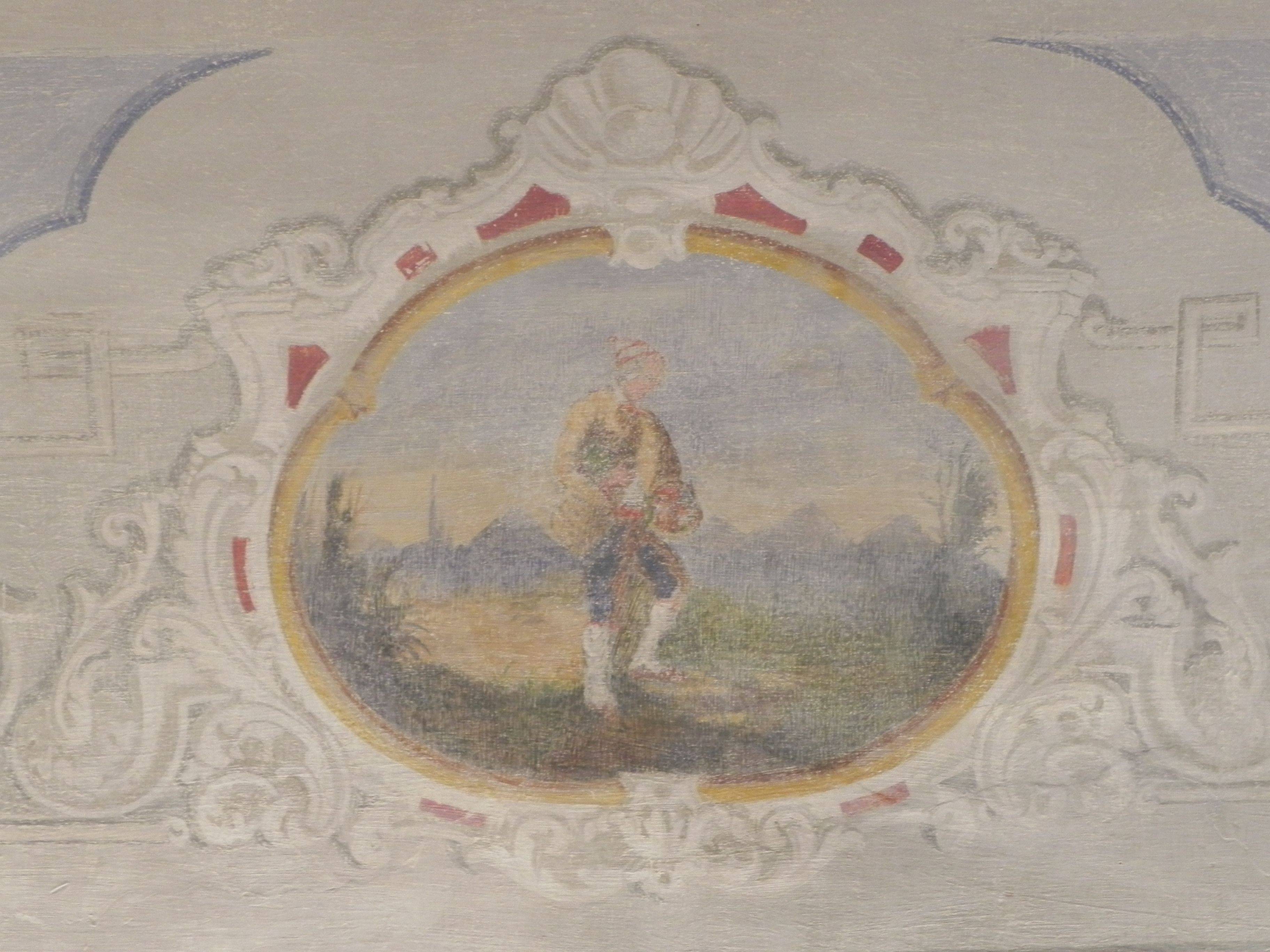 A ceiling with a circular portrait surrounded by ornate molding.