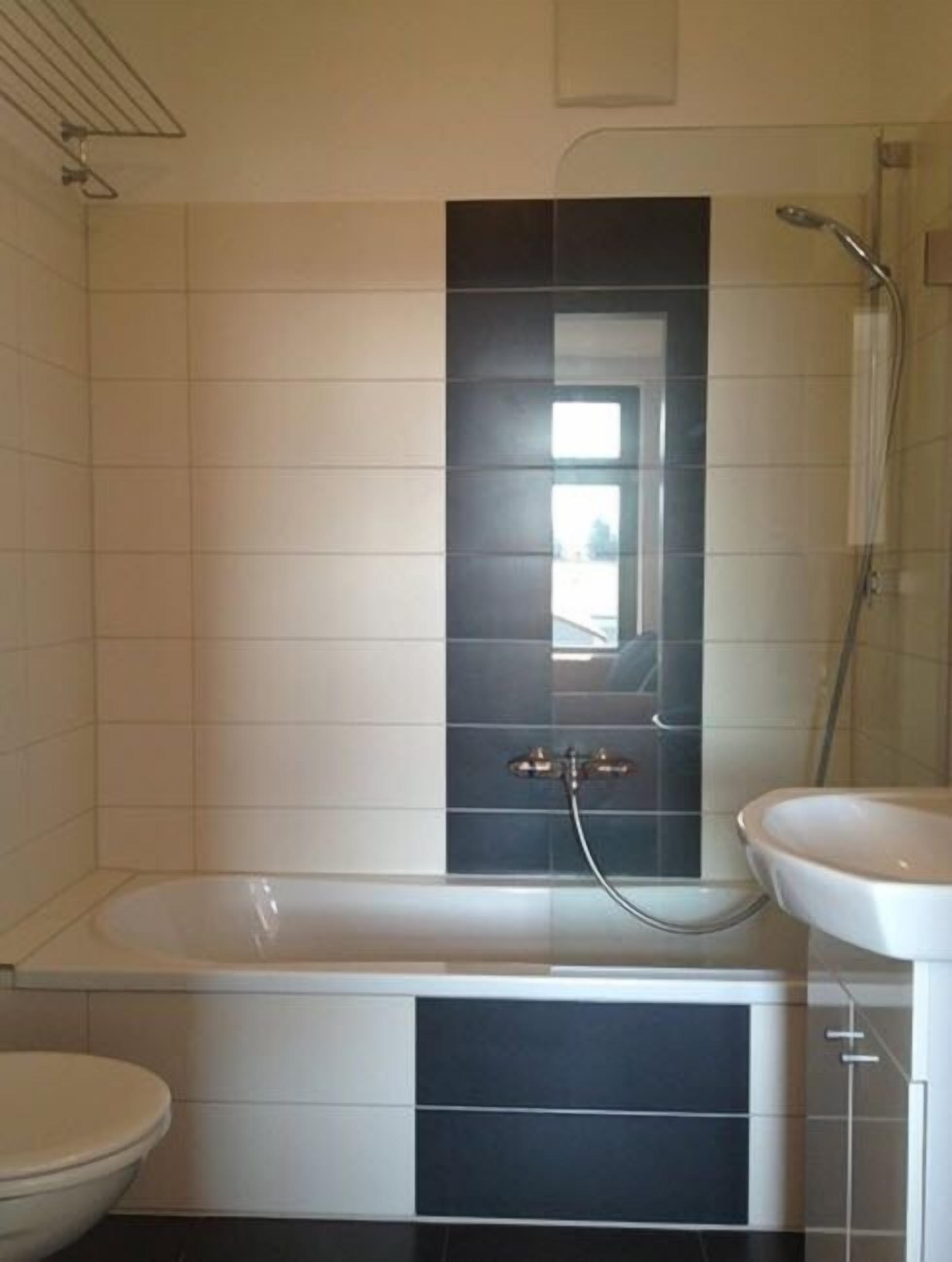 A bathroom with a bathtub, a toilet, and a sink.